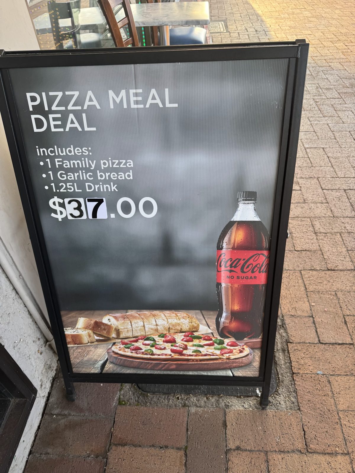Pizza meal deal board: one family pizza, garlic bread and a drink