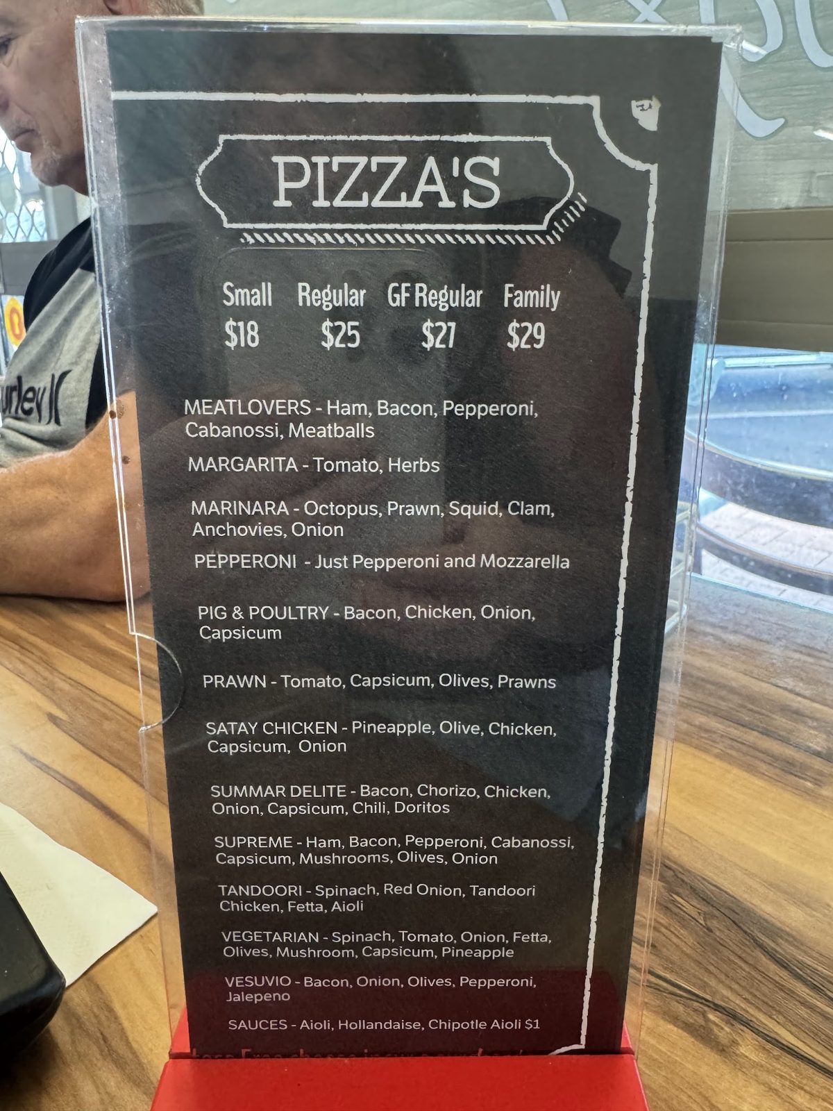 The pizza menu on a table stand