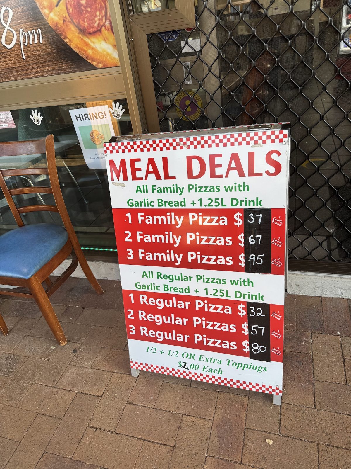 The red and white meal deals board outside the shop on Drayton Street