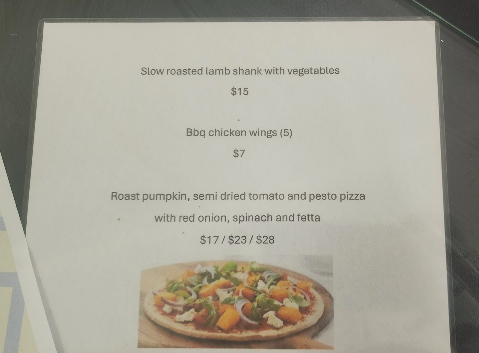 A specials sheet with lamb shank, wings and a pumpkin pizza